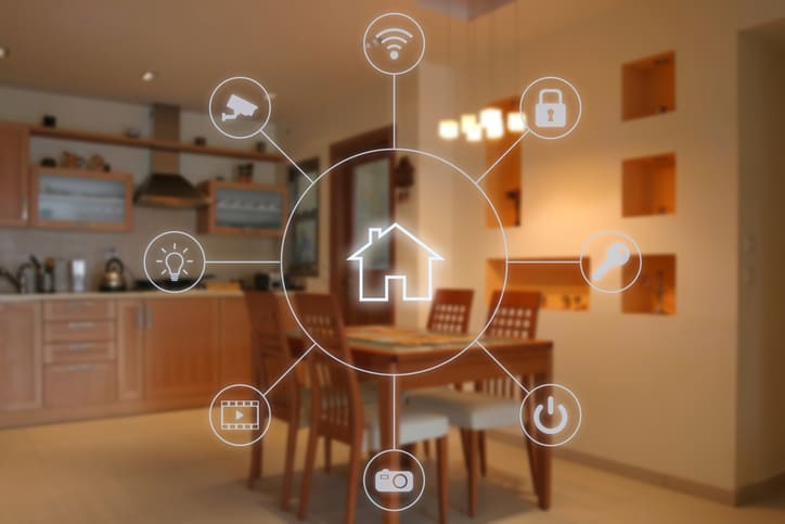 Concepto de domótica en un interior de casa con iconos interactivos de automatización del hogar superpuestos sobre la imagen de una cocina y comedor moderno.